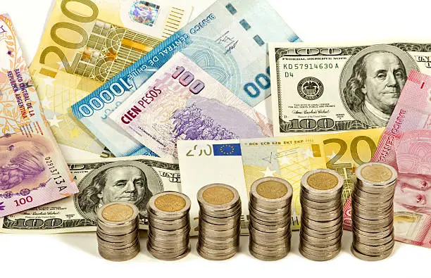 Currencies of different countries and economy level indicator with coins.