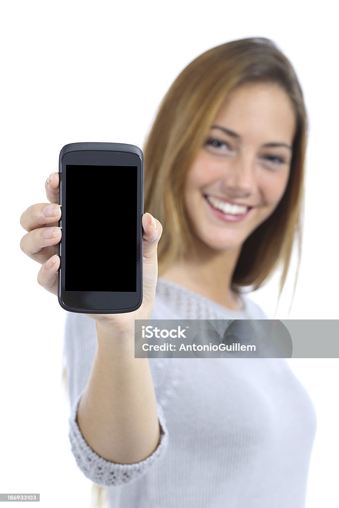 Happy pretty woman showing a blank smart phone screen Happy pretty woman showing a blank smart phone screen isolated on a white background Showing Stock Photo