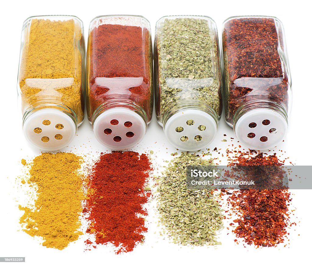 Spice Spill Spices being poured out of spice jars isolated on white background Basil Stock Photo