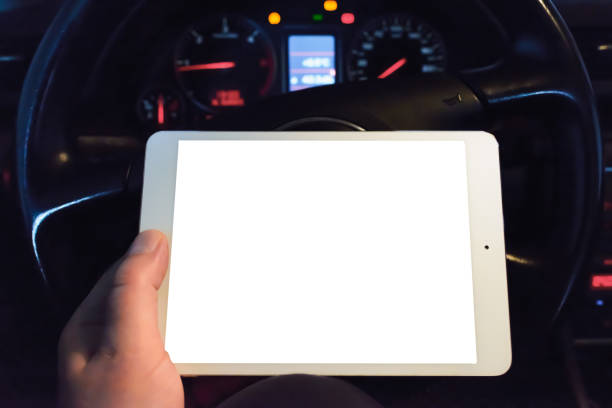 istock Mockup white screen.A mechanic looking at pc digital tablet in a car service garage.car engine test dashboard.Transportation service and maintenance working action. 1869332647