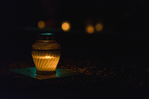 Memory lantern with burning candle in the dark.White Candles Burning in the Dark Night with lights glow.Copy space.