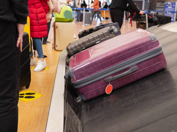 istock Suitcases on baggage carousel at the airport 1869338452