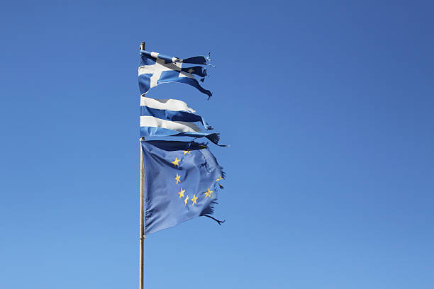 rasgado griegos y bandera de la comunidad europea - euro symbol crisis time debt fotografías e imágenes de stock