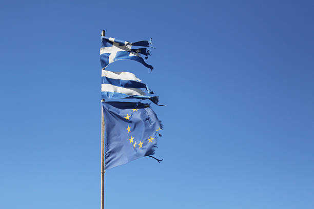 Torn Greek flag and torn European Union flag on blue background - horizontal