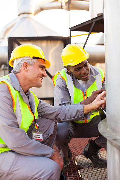 istock petrochemical technicians inspecting fuel tank 186935256