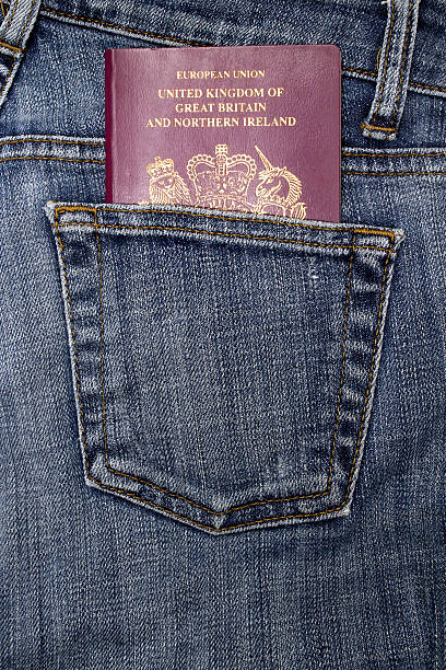 Passport in a pocket British passport in a denim jeans pocket jeans denim passport pocket stock pictures, royalty-free photos & images