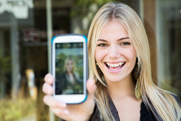 istock Pretty Young Blonde Taking Picture of Self 186937646