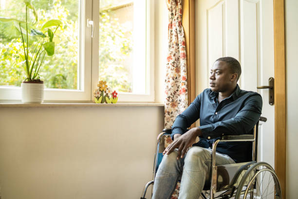 istock A lonely looking wheerchair user sitting by a window 1869381361