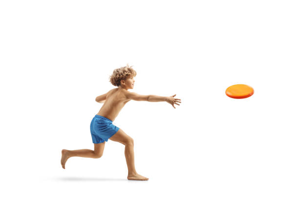 istock Boy in swimming shorts throwing a flying disc 1869382324