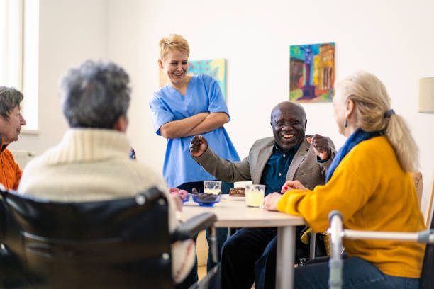 istock A female orderly sharing jokes with nursing home residents 1869384429