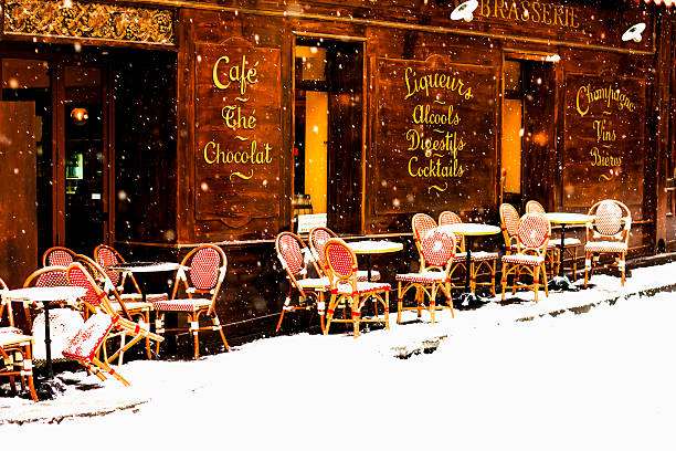 parisian café under snowfall - cafe snow stockfoto's en -beelden