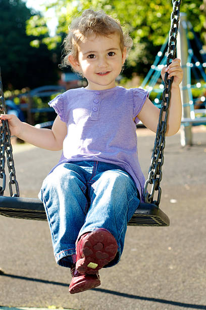 istock Young child on a swing in the playground at park 186939280