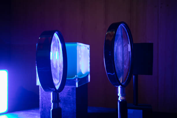 istock Optical lenses on stands in blue light in laboratory 1869392820