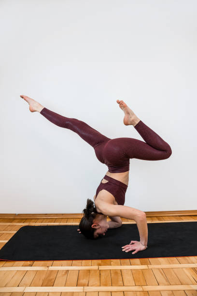 istock Caucasian fit woman doing exercise streching on yoga mat at studio 1869399671