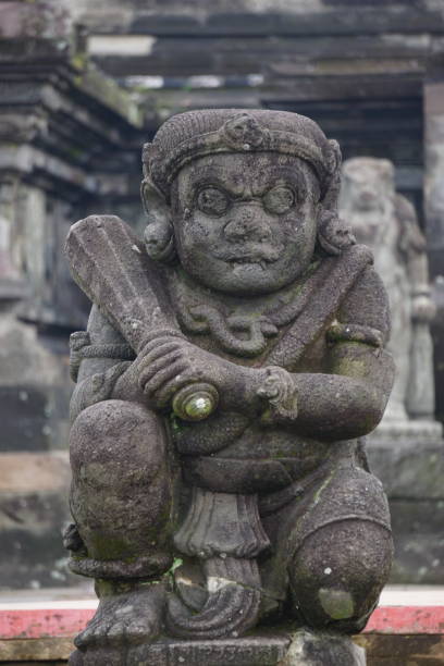 istock Dwarapala statue at penataran temple. Dwarapala is a gate guard who is often depicted as a scary warrior or giant, who carries a weapon in the form of a mace 1869401266