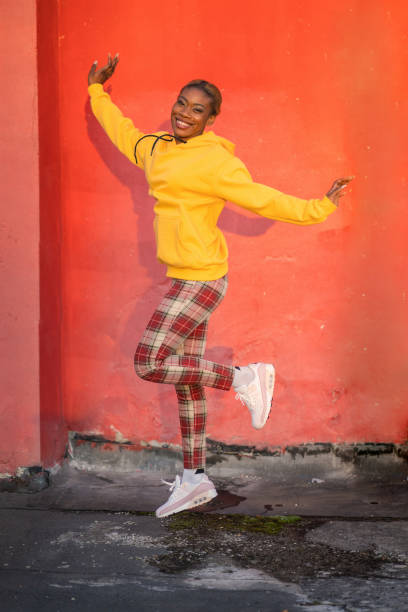 istock Woman hopping with arms outstretched 1869410537