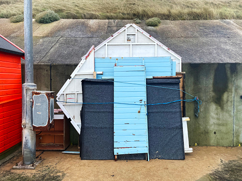 Flat packed beach hut on the promenade at Sheringham in Norfolk. December 2023