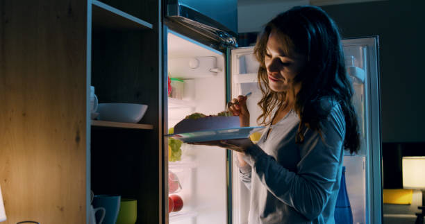 istock Happy woman having a midnight snack 1869437674