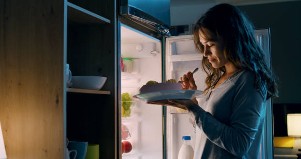 istock Happy woman having a midnight snack 1869438904