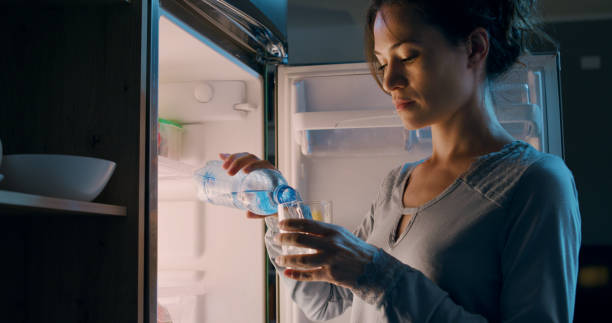 istock Thirsty woman drinking fresh water 1869439496