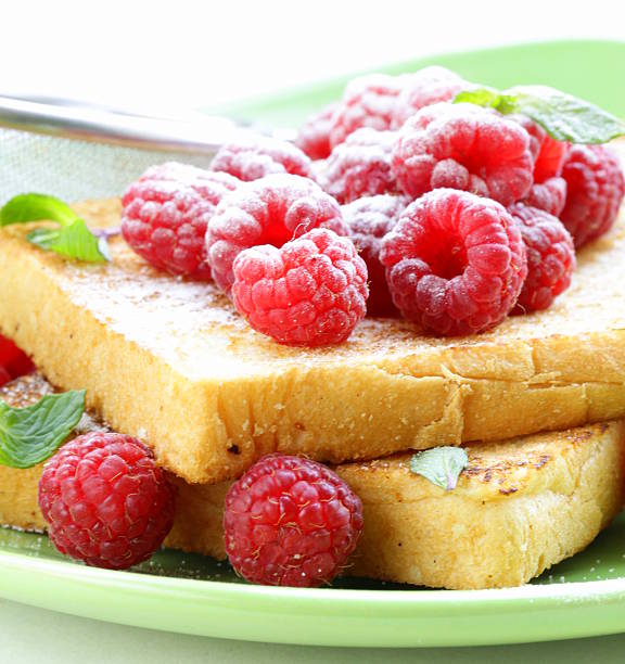 fresh toasted toast with raspberries and powdered sugar