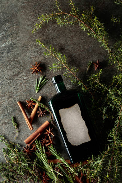 istock Vintage bottle, herbs, and spices on an old stone background. 1869455242