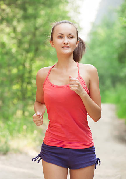 istock Young woman jogging outdoors 186946457