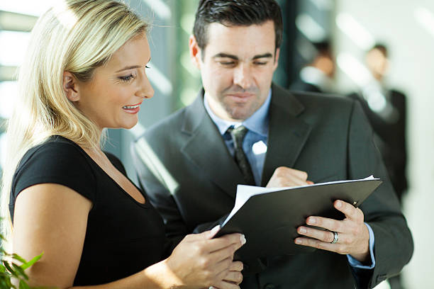 istock colleagues looking at monthly report 186946887