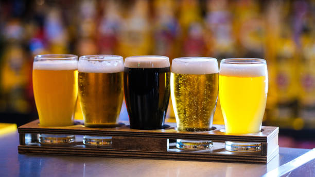 istock Different types of craft beer in glasses on table in pub interior in daylight 1869476169