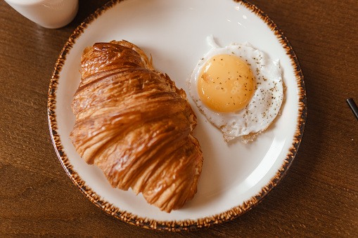 Croissant and egg on a plate