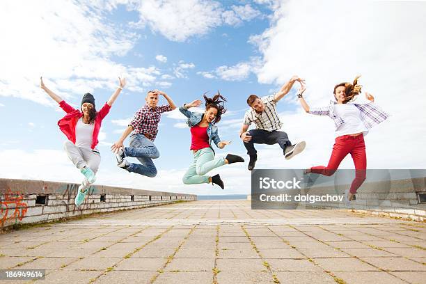 Group Of Teenagers Jumping On Street Stock Photo - Download Image Now - Dancing, Street, Breakdancing