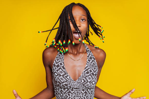 istock Young african woman dancing over yellow background 1869504702