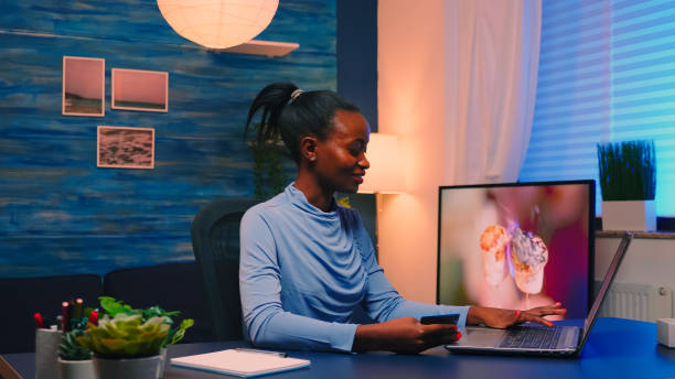istock Black business woman making transaction from home using credit card 1869506913
