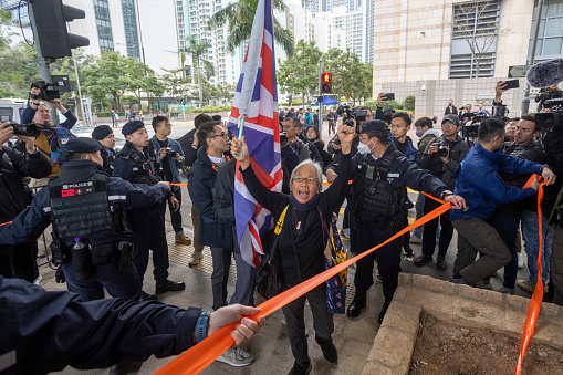 Dec 18 2023,Hong Kong.Alexandra Wong, a protester known as Grandma Wong, holds a British Union flag outside the West Kowloon Magistrates' Courts ahead of a hearing for former media mogul Jimmy Lai .