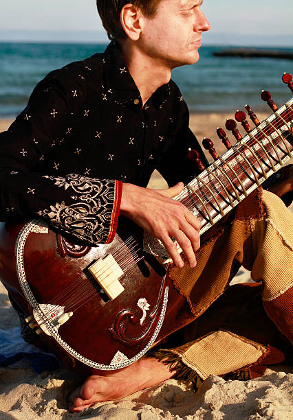 Plays sitar near the beach