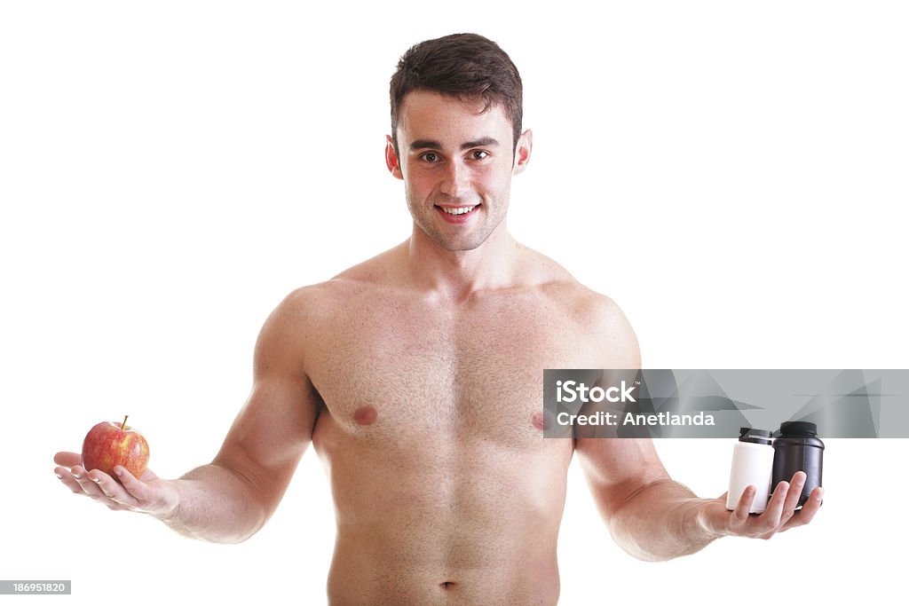 vitamin or pills drag tablet boxes supplements Man isolated natural apple vitamin or pill drag tablet Man isolated offering apple in one and pills in bottle - in another hand. Copy space boxes with supplements Abdomen Stock Photo