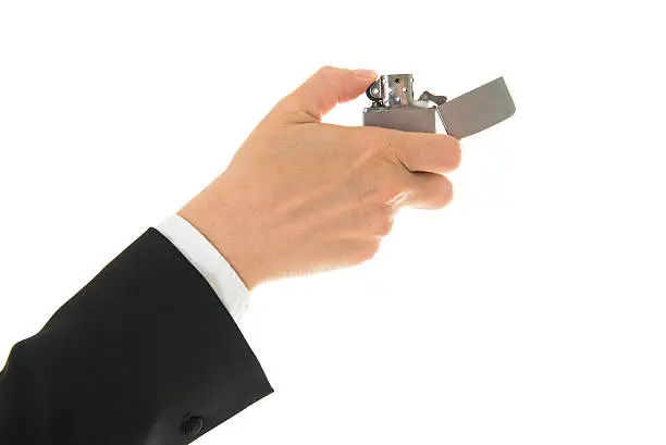 Lighting a  lighter on white background