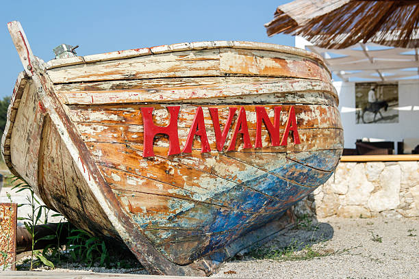 old battered boat on the beach stock photo