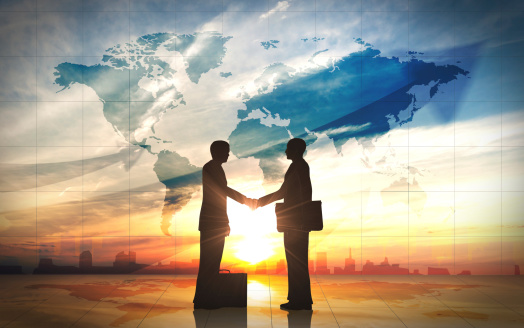 Two business man shake hand silhouettes city with world maps rendered with computer graphic.