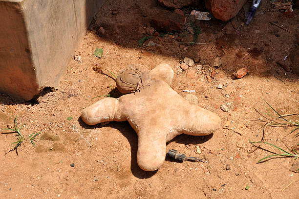 Handmade Doll Sits On A Dirt Road