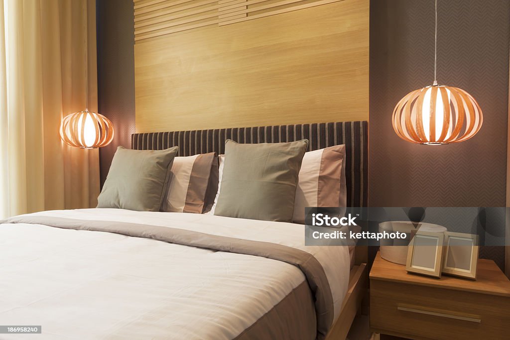 bedroom luxury bedroom decorated with wood. Apartment Stock Photo