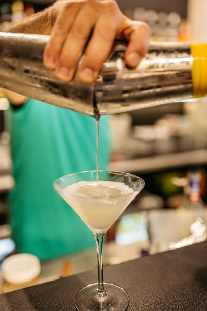 istock Mid-Adult Bartender Making An Apple Martini On The Bar Counter 1869584776