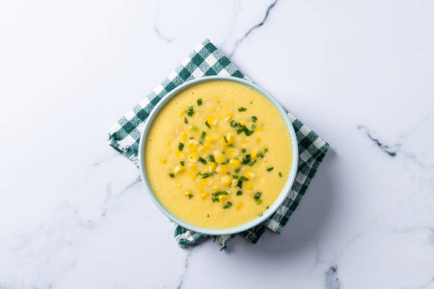 istock Corn soup in green bowl on white marble 1869588520