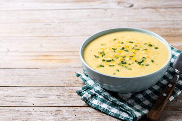 istock Corn soup in green bowl on wooden table 1869590080