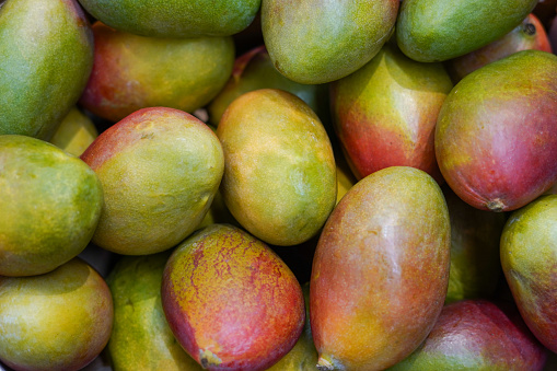 mangos background, fresh fruits mango in the grocery store