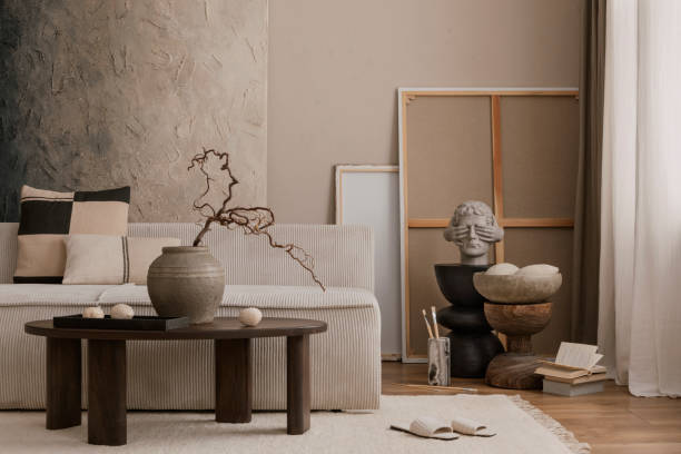 istock Creative composition of cozy living room interior with mock up poster frame, modular sofa, wooden coffee table, vase with branch, beige carpet, wooden sideboard, black stand, pillow and accessories. 1869598627