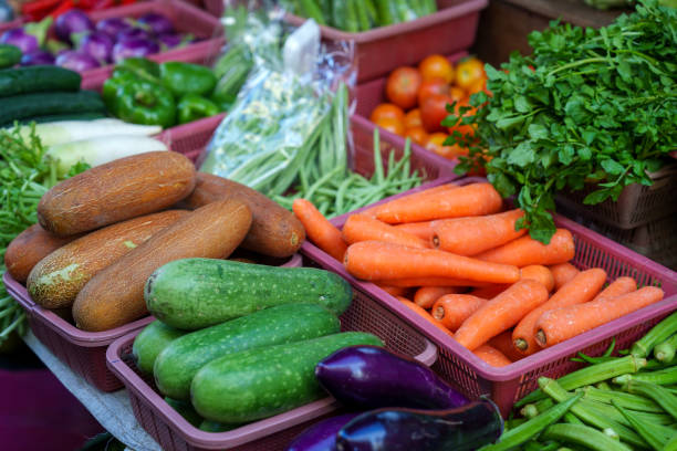 An array of multi-colored fruits and vegetables showcased on a market stall in Penang, Malaysia.