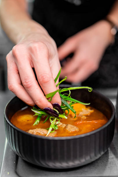 istock Professional chef cooking Shurpa soup with lamb meat in restaurant kitchen 1869609854