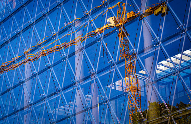istock Yellow construction cranes in the city. 1869613669
