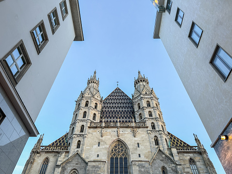 High section of Cathedral among buildings in downtown, Vienne, Austria
